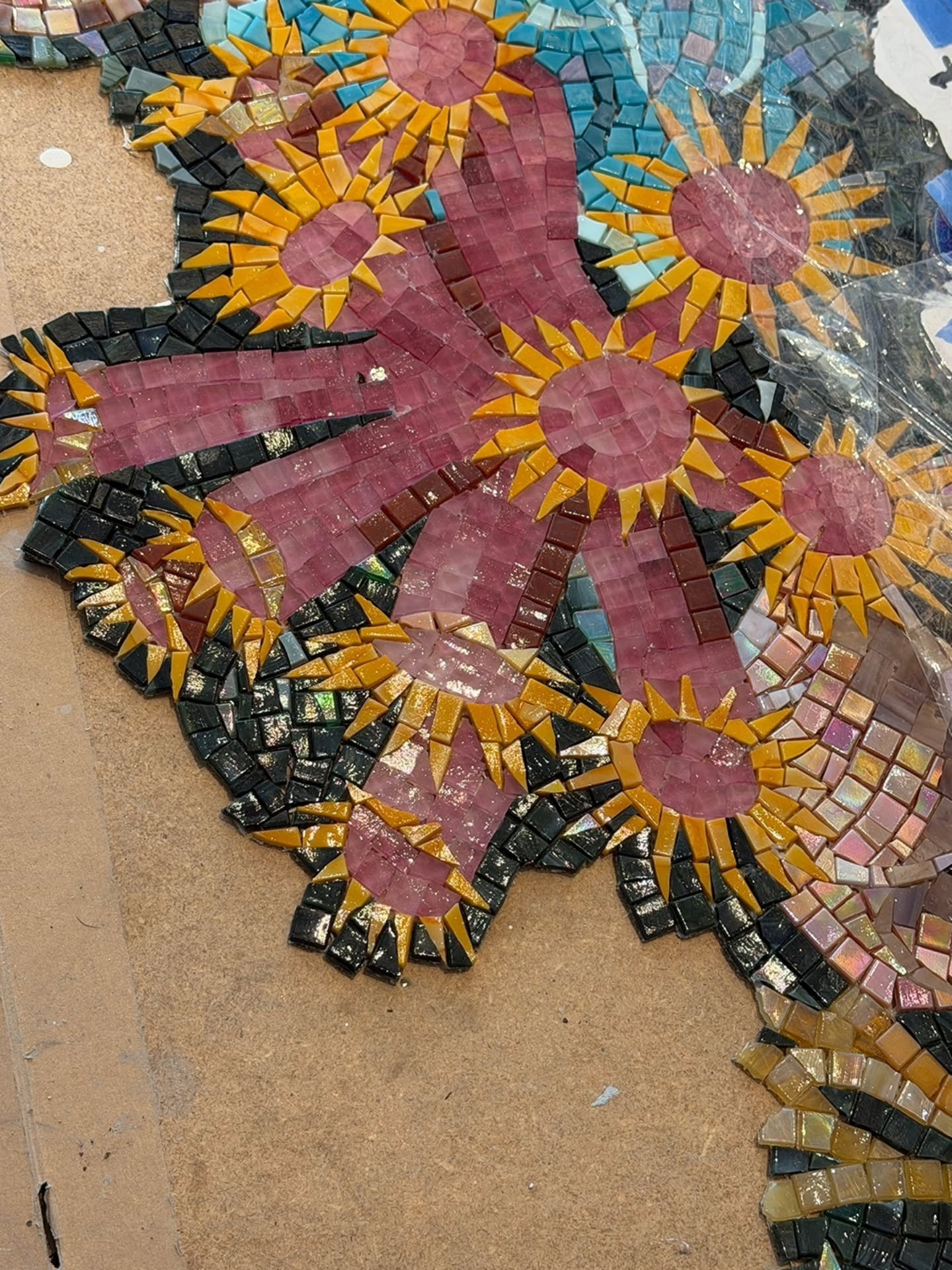 Close detail of hand-cut mosaic tiles forming sea anemones and coral forms