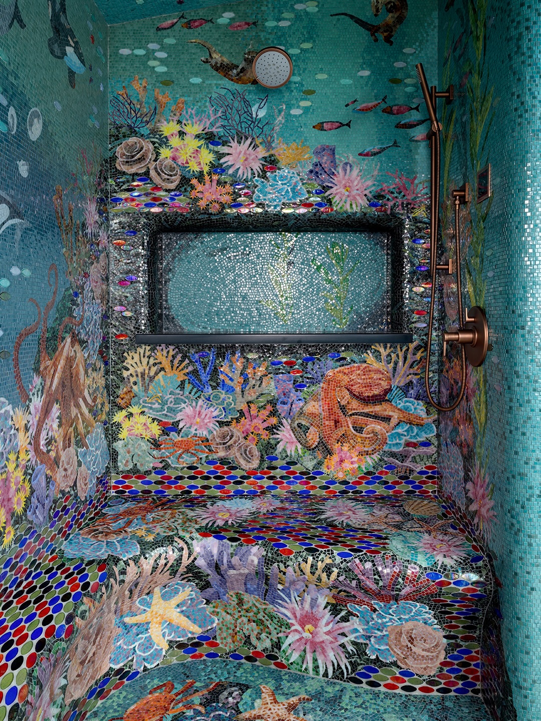 Shower niche and bench detail showing continuous hand-laid mosaic tile work